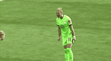 a group of soccer players are hugging each other on a field .