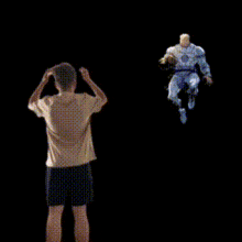 a man in a white shirt and black shorts is standing in front of a flying figure