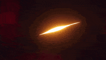 a glowing light that looks like an eye is coming out of a hole