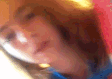 a blurry picture of a person 's face with red hair