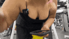 a woman in a black tank top with the letter w on her chest