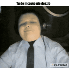 a man wearing headphones and a tie has the caption tu do niczego nie doszło