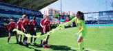 a group of female soccer players on a field with a banner that says real madrid on it