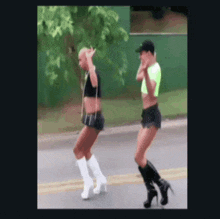two women are walking down a street wearing high heels