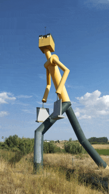 a statue of a man with a box on his head and a briefcase on his leg
