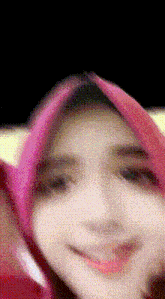 a close up of a woman wearing a pink scarf