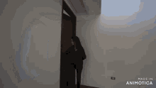 a person is opening a door with the words made in animotica on the bottom