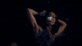 a group of people are dancing in a kitchen in a dark room