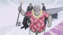 a man wearing a hawaiian shirt with flowers on it is standing in the snow
