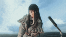 a woman wearing a helmet and glasses looks down at something