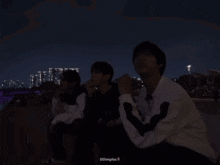 a group of people are sitting in the dark with dimples written on the bottom right