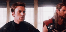 captain america and thor are standing next to each other