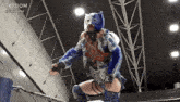 a female wrestler in a blue and white costume with the word stardom on the bottom right corner
