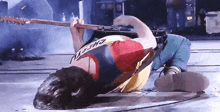 a man laying on the floor playing a guitar with a shirt that says " myth " on it