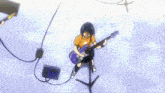 a group of people are playing guitars and drums on a stage
