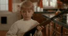 When Someone Starts Sassing You GIF - Macaulay Culkin Gun Cant GIFs