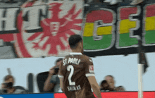 a soccer player wearing a jersey with the number 2 on the back