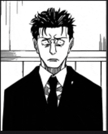a man in a suit and tie is looking at the camera .