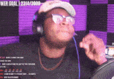 a man singing into a microphone with a web goal of 2314/36000