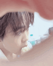 a close up of a person 's face with a reflection of their face in a mirror