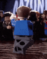 a lego man is standing in front of a sign that says gazing