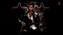 a man singing into a microphone and playing a guitar