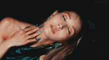 a close up of a woman 's face with dokyungsoo written on the bottom right