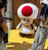 a stuffed toad with a red and white circle on his head