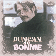 a man with glasses and a mustache has the name duncan de bonnie on his shirt