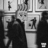 a black and white photo of a man wearing a cartoon head