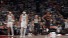 a blurry picture of a basketball game with a cnn logo on the bottom