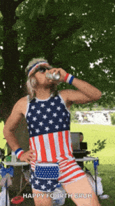 a man wearing an american flag outfit is drinking a beer