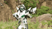 a white and green superhero is holding a large sword