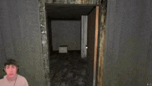 a person in a video game is looking at a door with the letter e in the corner