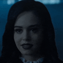 a close up of a woman 's face in a dark room .