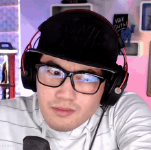 a man wearing headphones and a hat that says hey guys on it