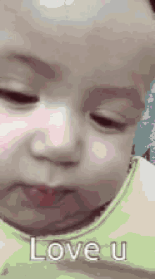a baby is making a face and says `` love u '' .