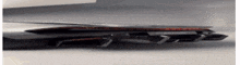 a close up of a car 's rear bumper and exhaust pipe .