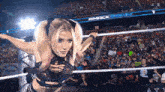 a woman in a wrestling ring with a banner that says bmackdown
