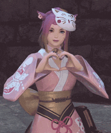 a girl wearing a pink kimono and a cat mask makes a heart shape with her hands