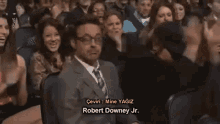 a man in a suit and tie is dancing in front of a crowd with a caption that says mine yagiz .