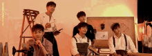 a group of young men are posing for a picture with the website onedrive.tumblr.com in the background