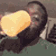 a man is drinking a bottle of orange juice .