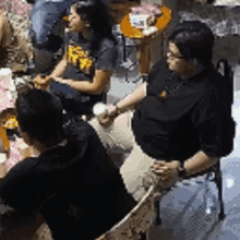 a group of people are sitting at a table eating food .