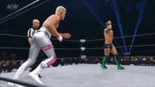 a wrestler in a ring with the aew logo