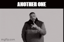 a black and white photo of a man pointing at the camera with the caption another one
