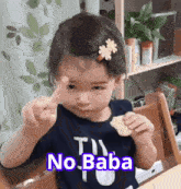 a little girl with a flower in her hair is sitting at a table with the words no baba written on the bottom