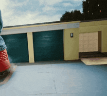 a person standing in front of a garage with a light on the side of it