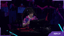 a man wearing a pink and blue shirt that says youc1000