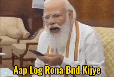 a man with a beard is holding a cell phone and says aap log rona bnd kiiye
